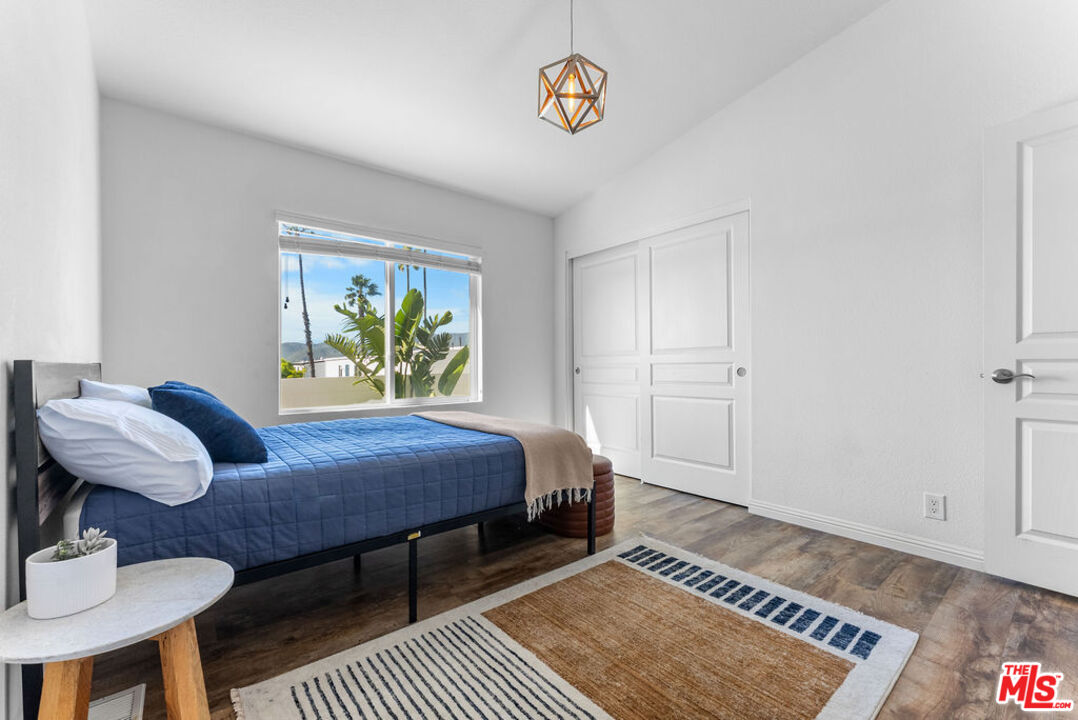 29500 Heathercliff Road, Unit 70 Malibu, CA 90265 - Photo 8 of 38 a bedroom with a bed dresser and a window