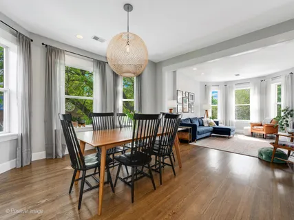 a view of a dining room with furniture window and wooden floor
