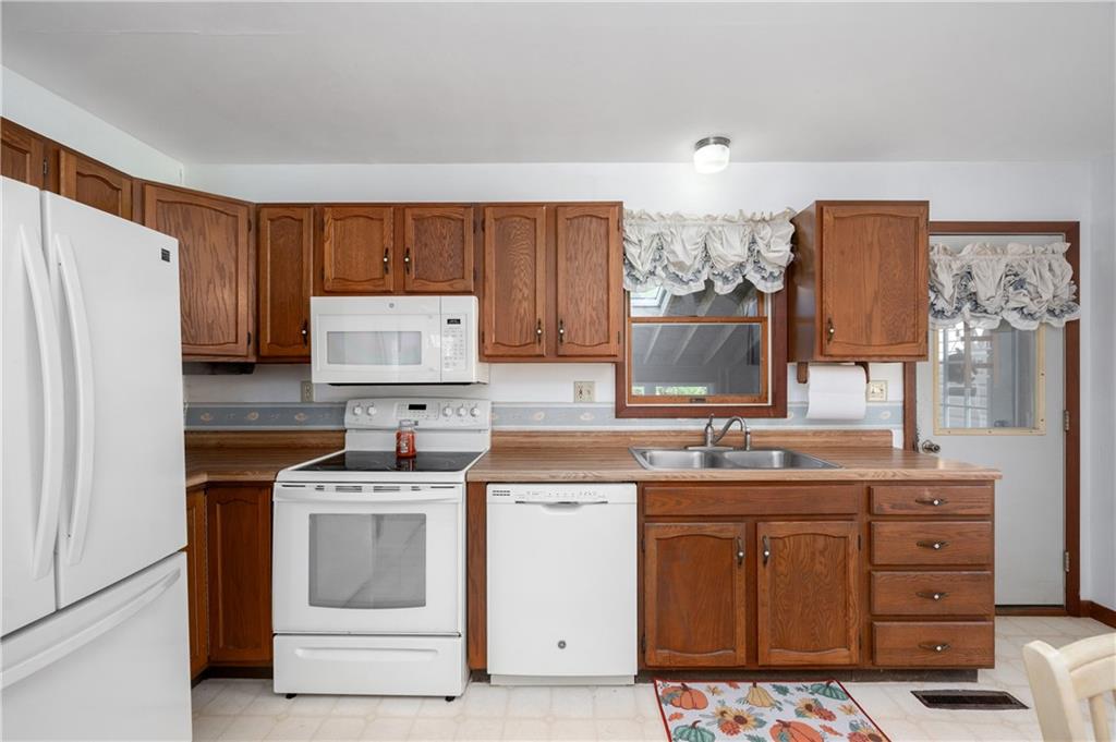232 Pfeifer Road Harmony, PA 16037 - Photo 11 of 33 a kitchen with a stove a refrigerator and a sink