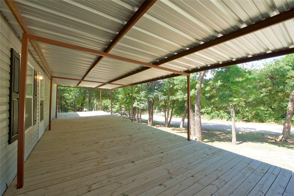 60 Tecumseh Road Valley View, TX 76272 - Photo 6 of 20 Expansive covered deck featuring wood plank flooring and a metal roof structure