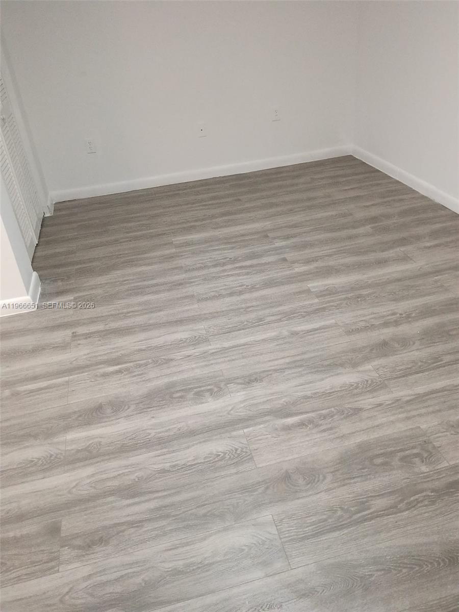 7130 Rue Versailles Drive, Unit 3 Miami Beach, FL 33141 - Photo 13 of 17 wooden floor in a empty room