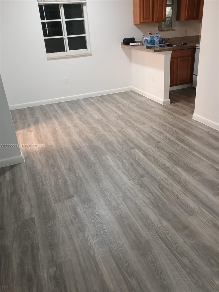 7130 Rue Versailles Drive, Unit 3 Miami Beach, FL 33141 - Photo 14 of 17 a view of a kitchen with wooden floor and a sink