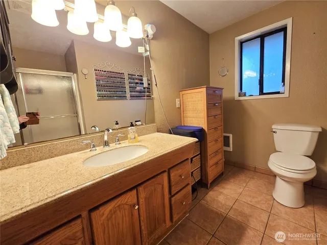 a bathroom with a sink a toilet and a shower