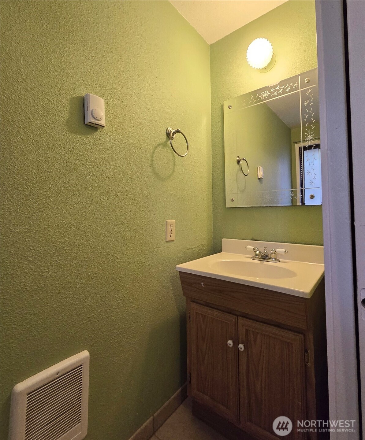 15 Kellogg Road Clallam Bay, WA 98326 - Photo 23 of 27 a bathroom with a sink mirror and vanity