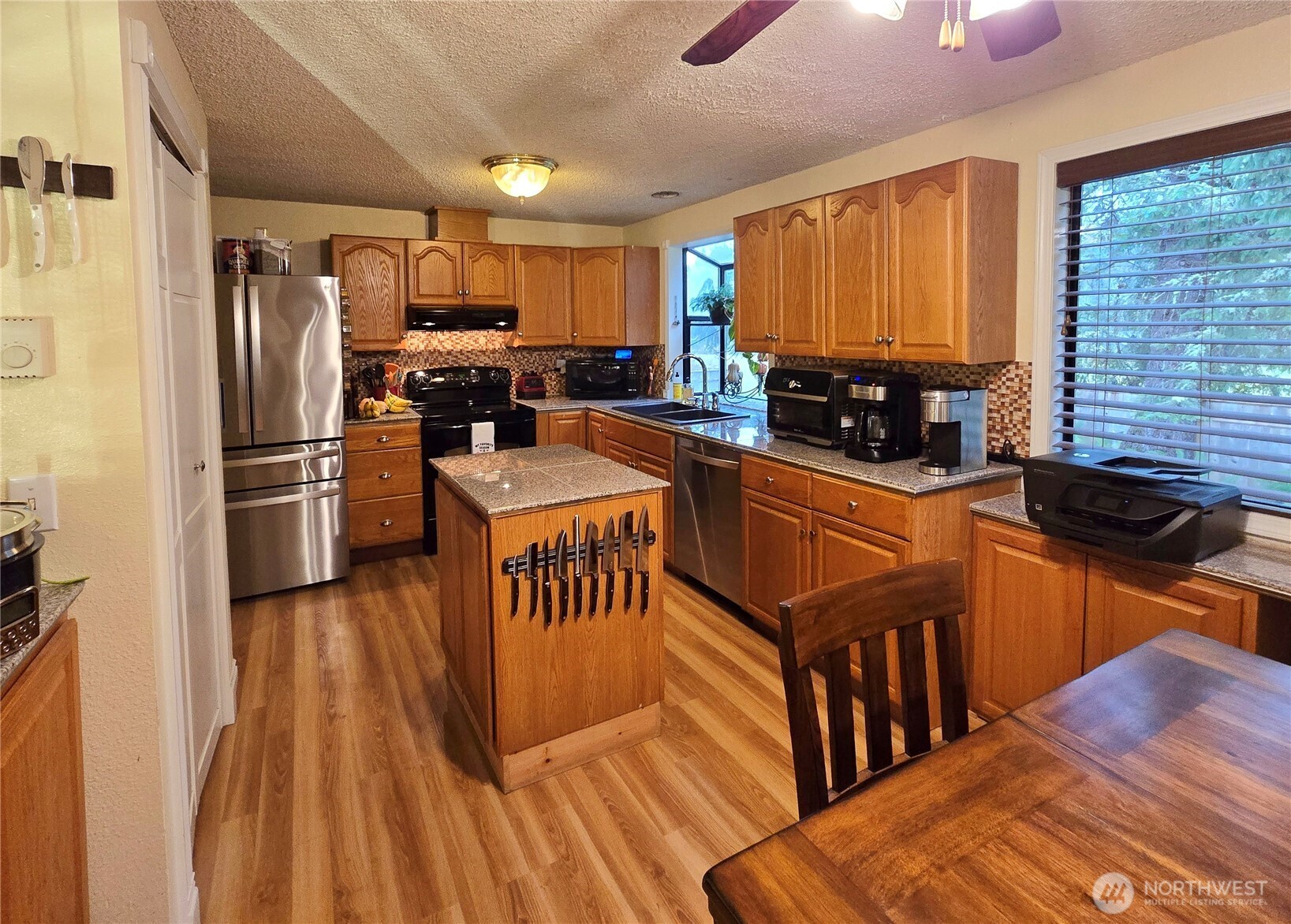 15 Kellogg Road Clallam Bay, WA 98326 - Photo 9 of 27 a kitchen with granite countertop a refrigerator stove top oven and sink