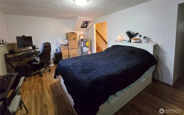 a bed sitting in a bedroom next to a window