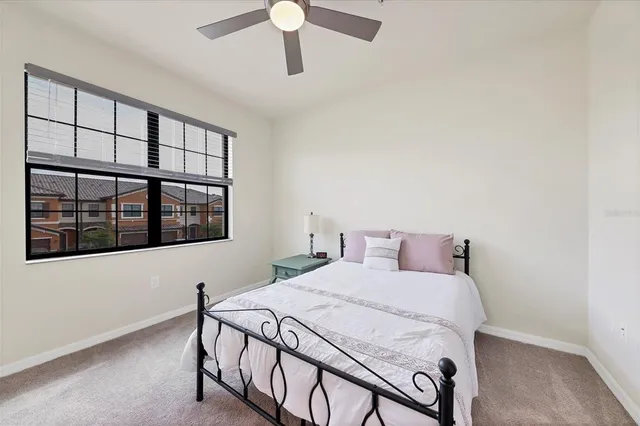 a bedroom with a bed and a large window