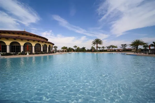 a swimming pool with outdoor seating and yard