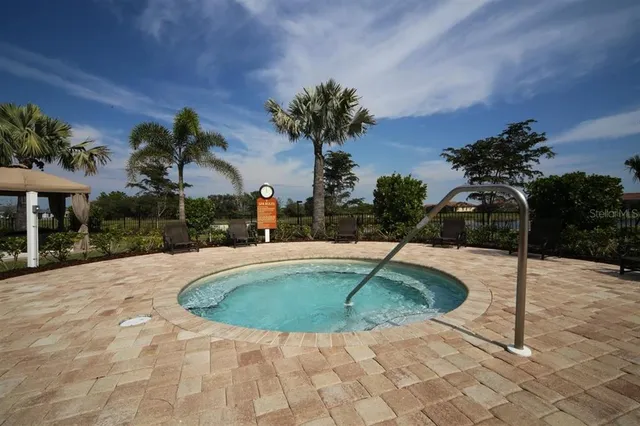 an aerial view of a swimming pool and mountain view in back