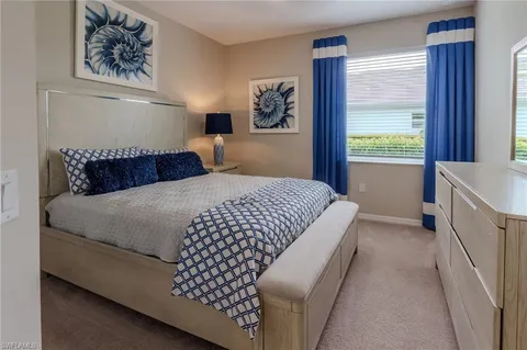 a bedroom with a bed and a lamp
