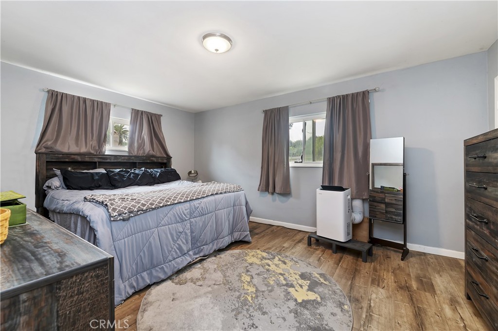 3075 Ronald Street Riverside, CA 92506 - Photo 20 of 30 a bedroom with a bed and wooden floor
