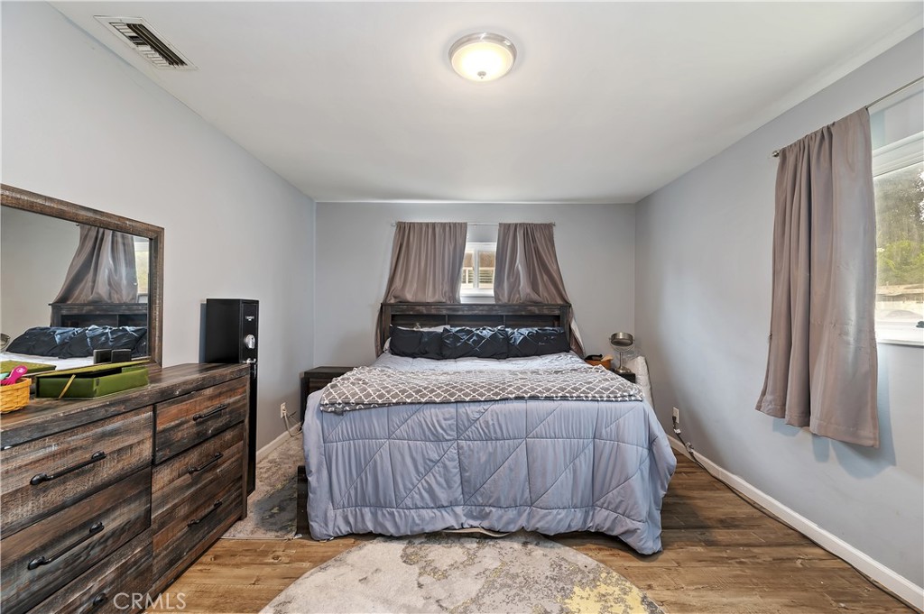 3075 Ronald Street Riverside, CA 92506 - Photo 21 of 30 a bedroom with a bed and a dresser with mirror