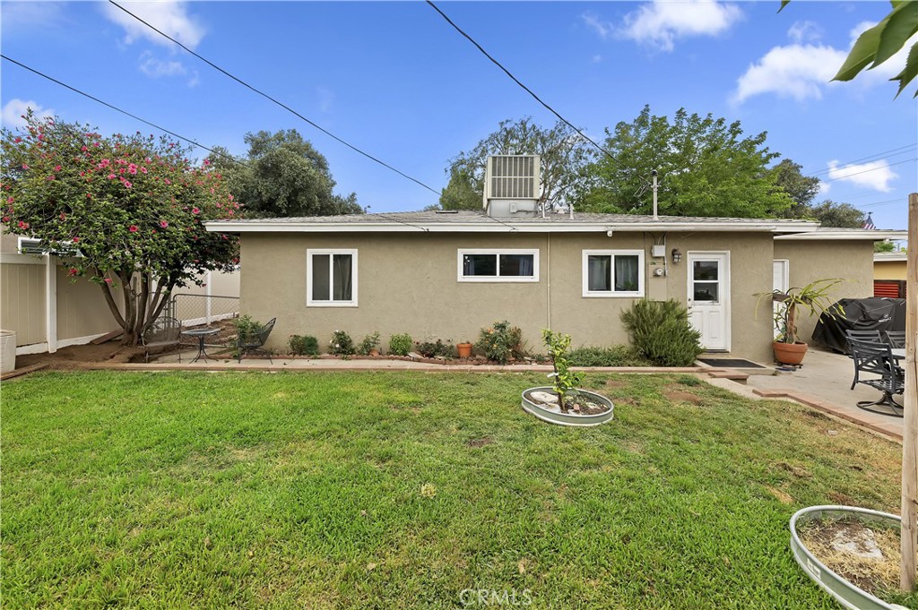 3075 Ronald Street Riverside, CA 92506 - Photo 27 of 30 a backyard of a house with table and chairs and potted plants