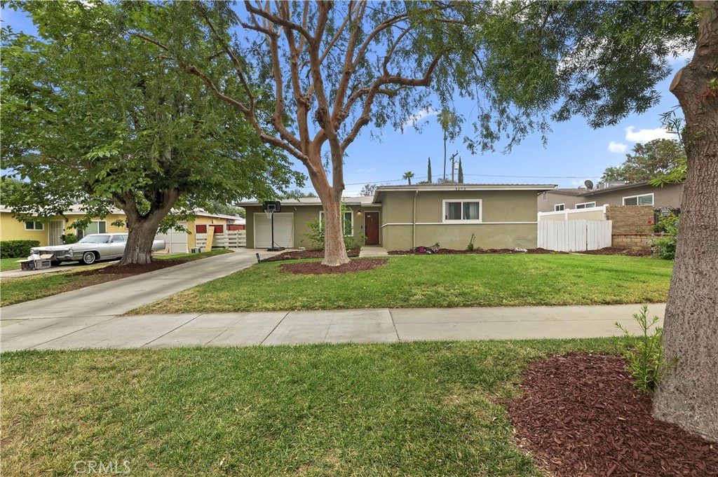 3075 Ronald Street Riverside, CA 92506 - Photo 3 of 30 a front view of a house with a yard and garage