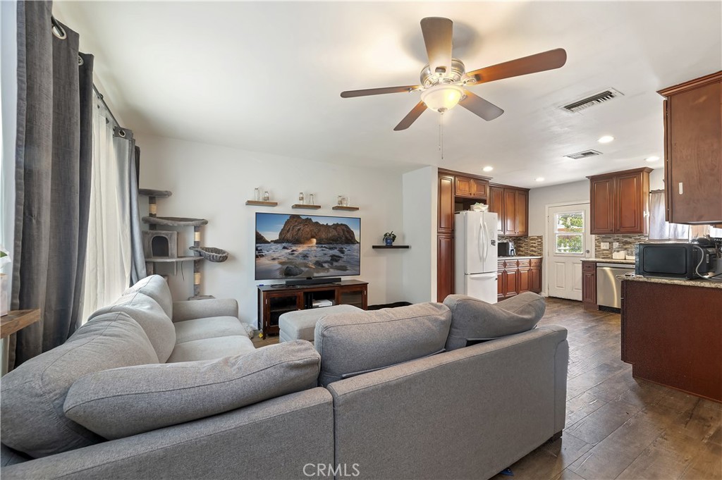 3075 Ronald Street Riverside, CA 92506 - Photo 6 of 30 a living room with furniture kitchen view and a chandelier