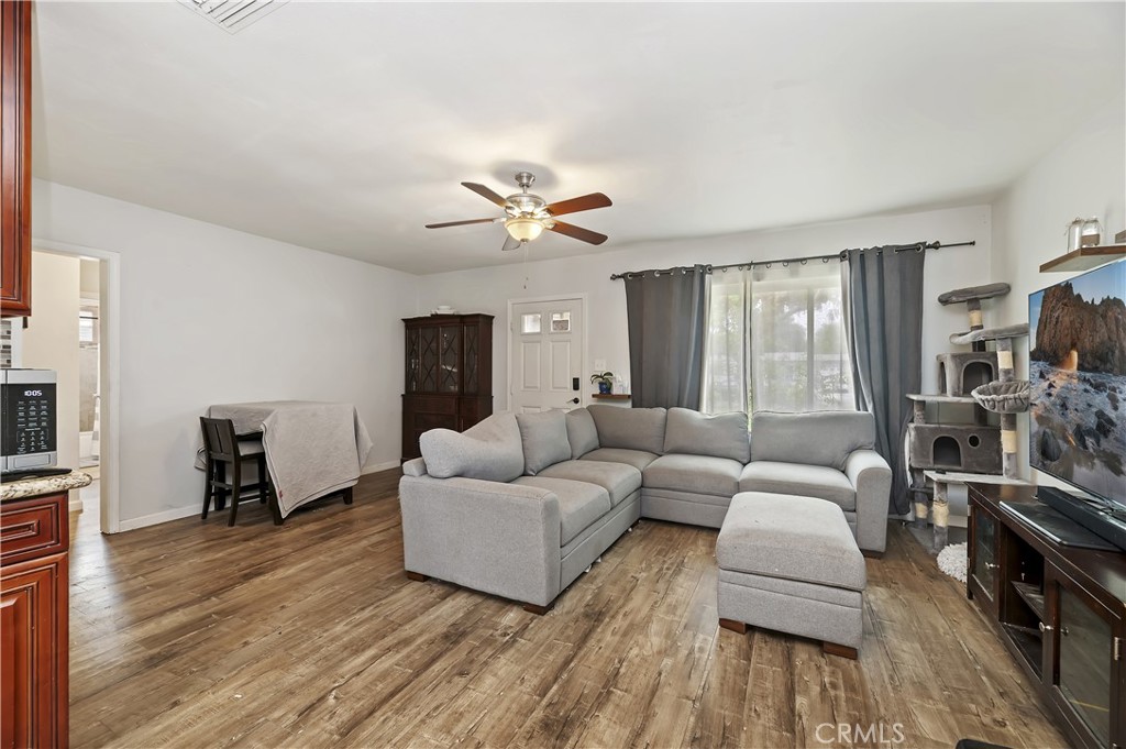 3075 Ronald Street Riverside, CA 92506 - Photo 9 of 30 a living room with furniture a fireplace and a flat screen tv