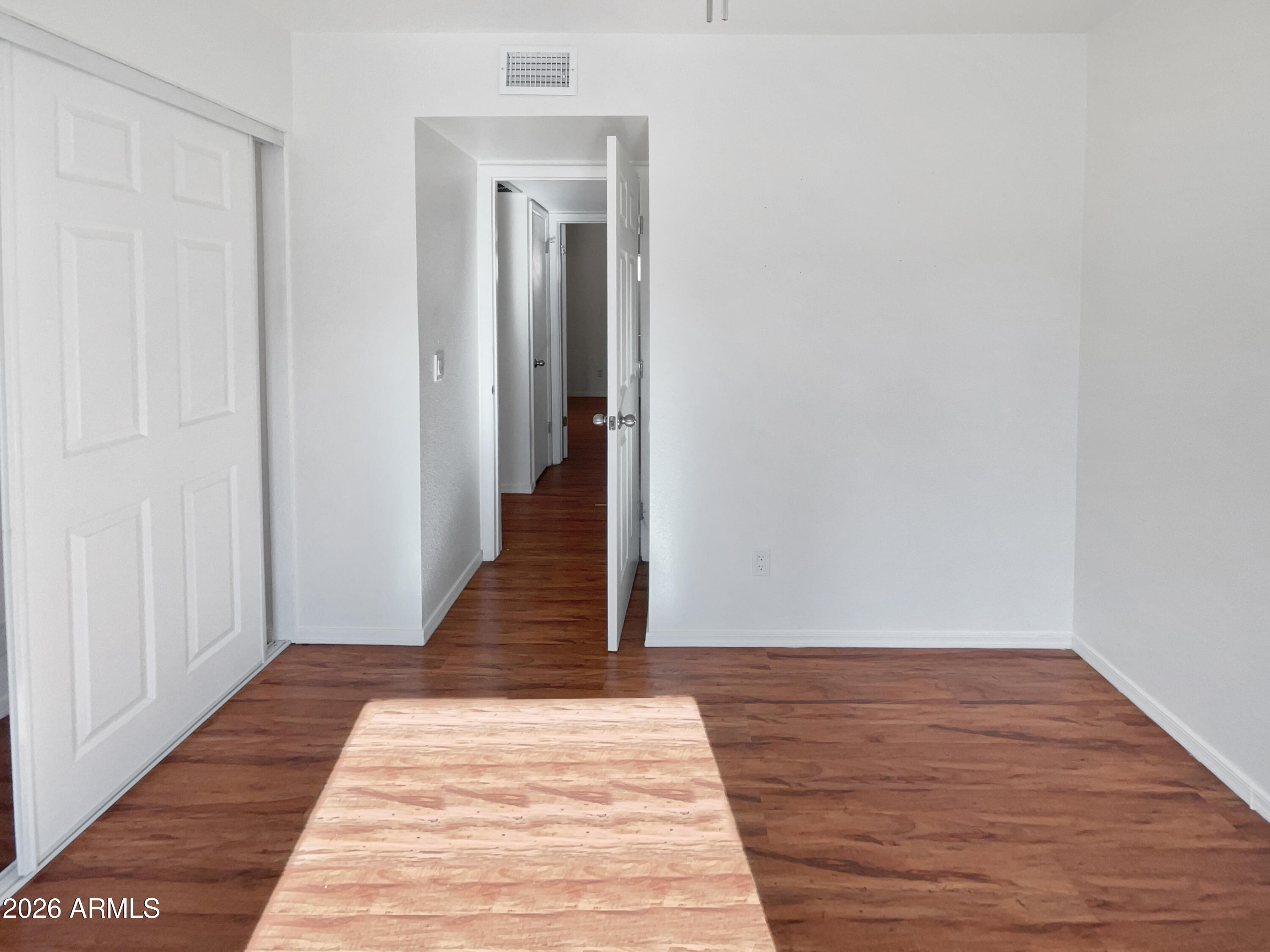 19002 North 14th Place Phoenix, AZ 85024 - Photo 11 of 27 a view of a hallway with wooden floor and staircase
