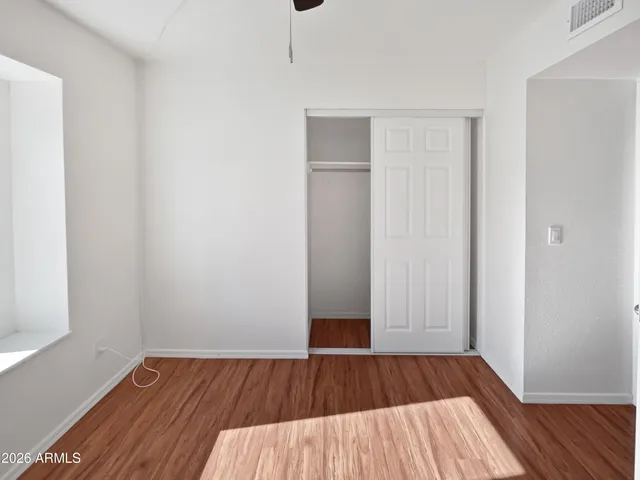 a view of a room with wooden floor