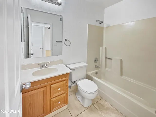 a bathroom with a sink toilet vanity and shower