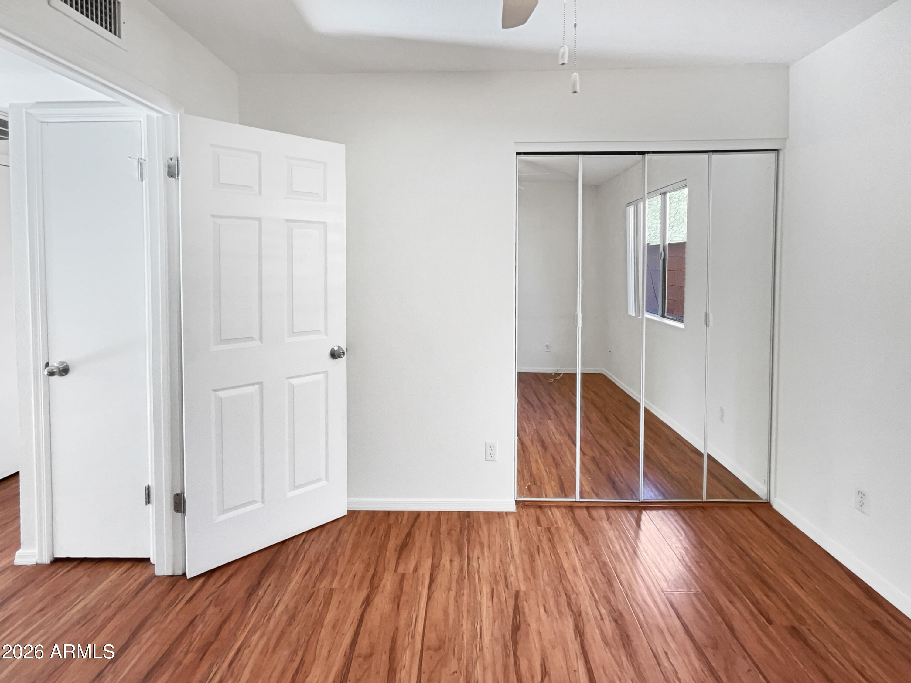19002 North 14th Place Phoenix, AZ 85024 - Photo 14 of 27 a view of an empty room with wooden floor and closet