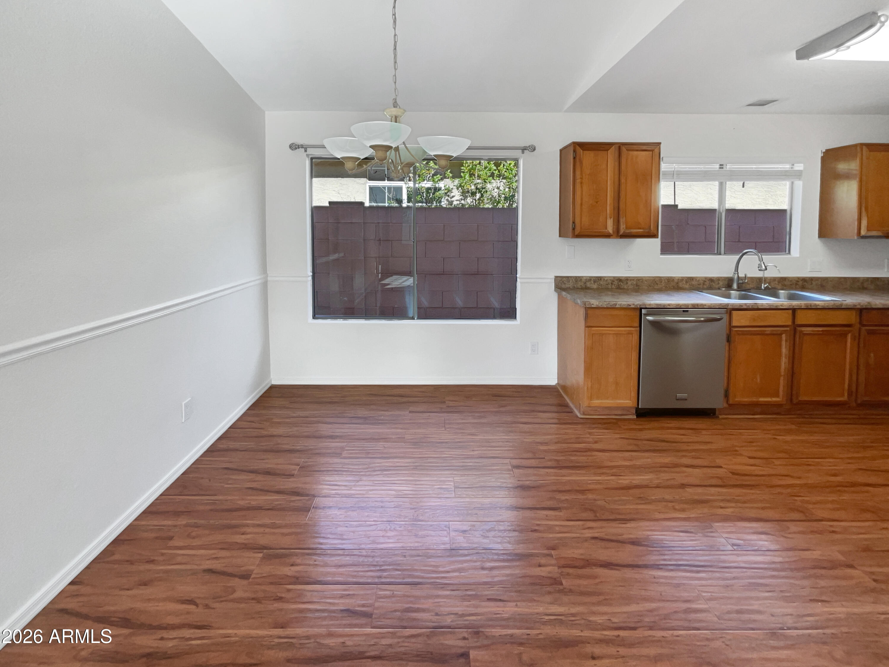 19002 North 14th Place Phoenix, AZ 85024 - Photo 16 of 27 a view of a kitchen with a sink dishwasher a stove top oven and wooden floor