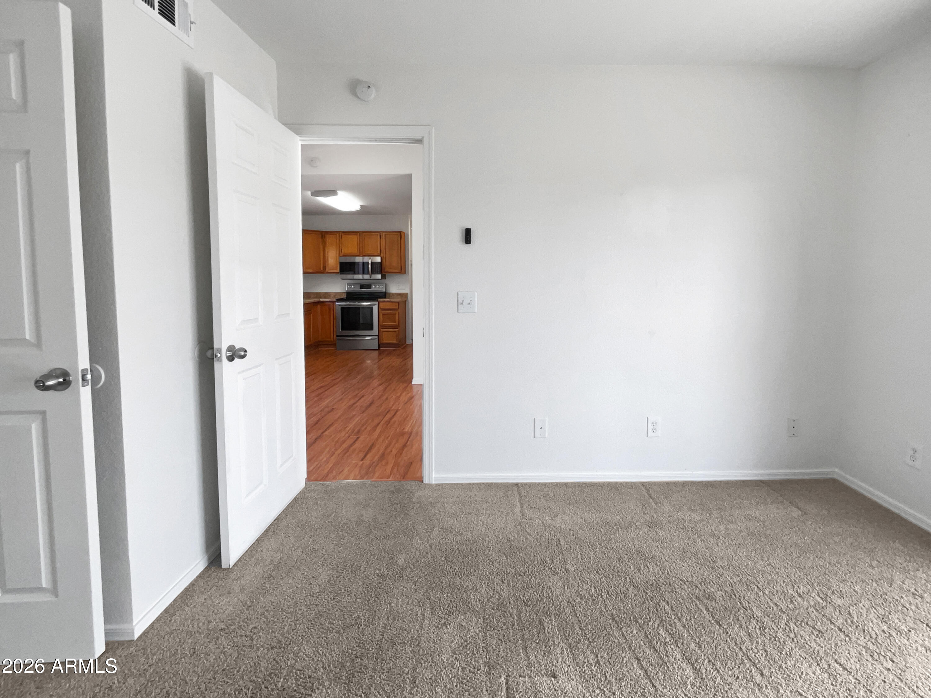 19002 North 14th Place Phoenix, AZ 85024 - Photo 21 of 27 a view of a hallway view with wooden floor and a kitchen