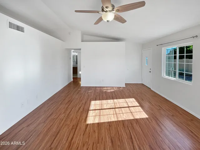 wooden floor in an empty room with a window