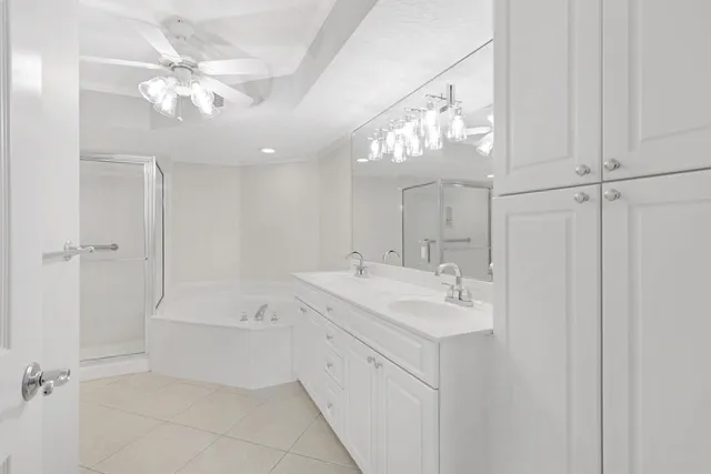 a bathroom with a sink a toilet a mirror and shower