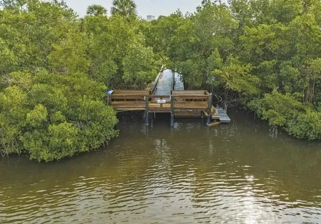 a room with pool table and windows