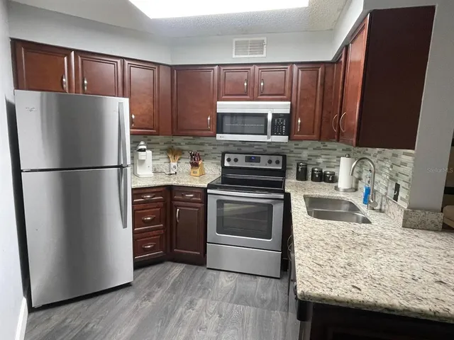 a kitchen with a refrigerator sink and microwave