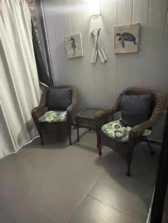 a living room with furniture and wall painting
