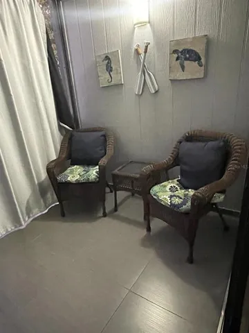 a living room with furniture and wall painting