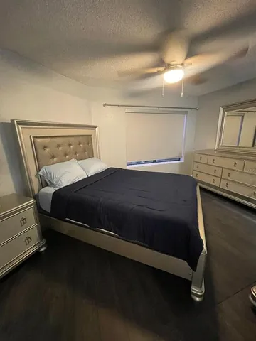 a bedroom with a bed and cabinets