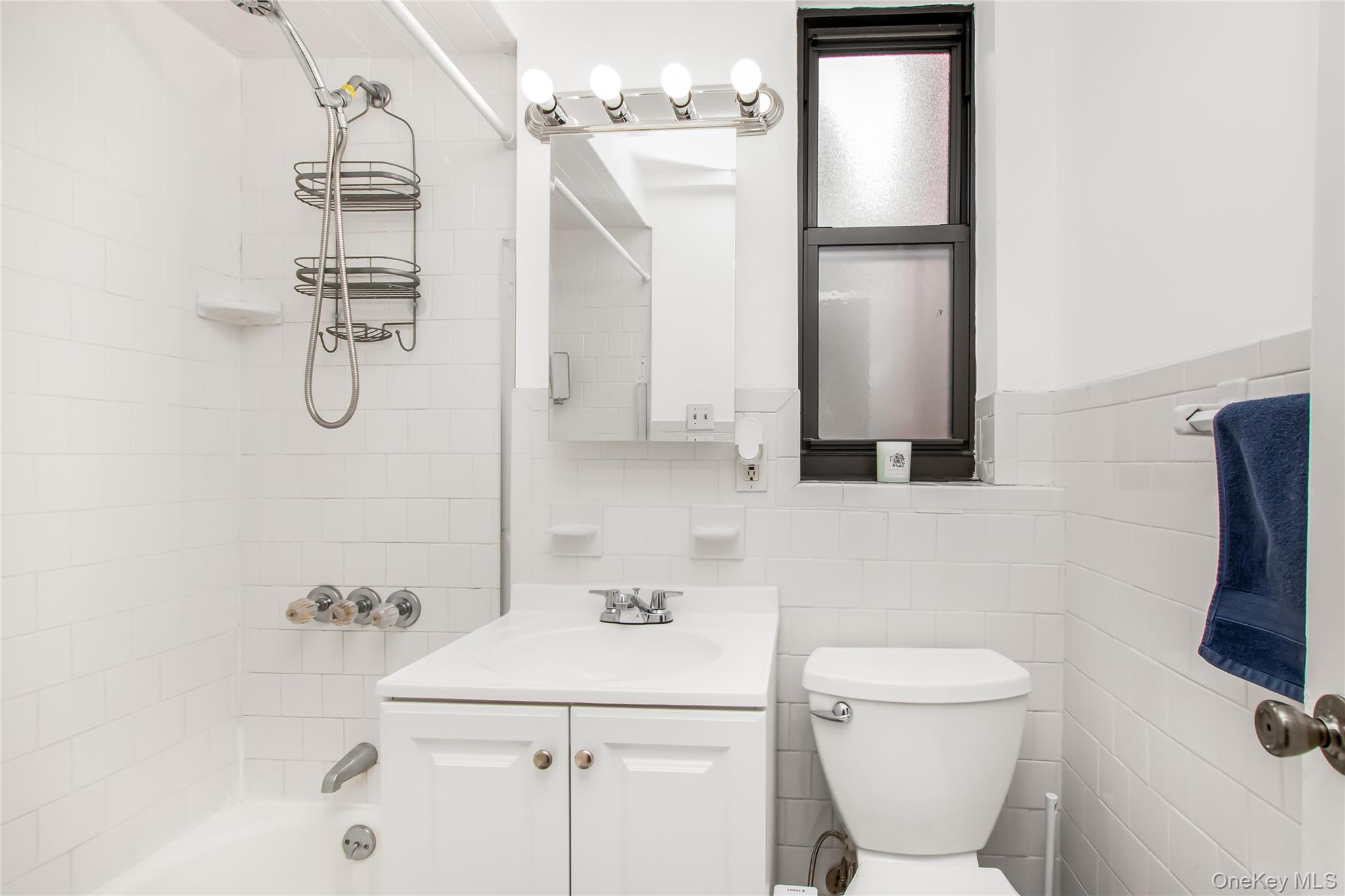 512 Kappock Street, Unit 1K Bronx, NY 10463 - Photo 8 of 11 a bathroom with a shower toilet and sink