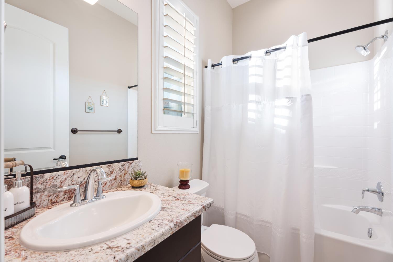 822 Overstone Avenue Madera, CA 93636 - Photo 21 of 49 a bathroom with a granite countertop sink toilet and shower