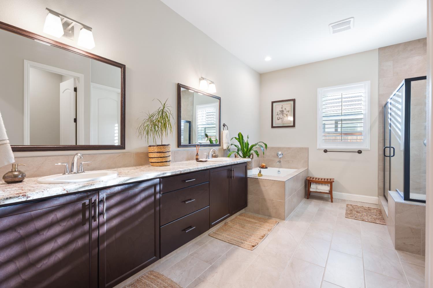 822 Overstone Avenue Madera, CA 93636 - Photo 24 of 49 a spacious bathroom with a granite countertop sink mirror and a bathtub