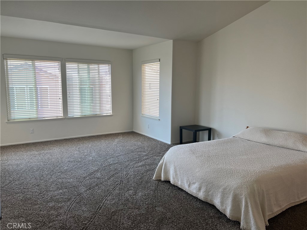 12772 Clemson Drive Eastvale, CA 92880 - Photo 15 of 28 a view of a bedroom with a bed and a window