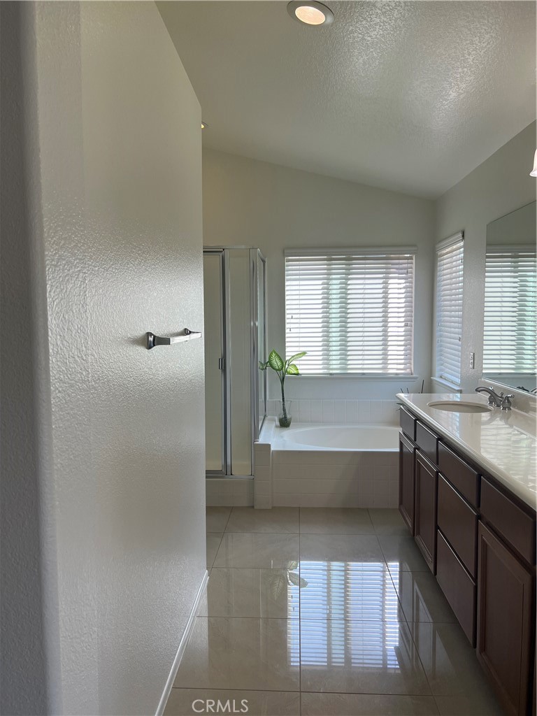 12772 Clemson Drive Eastvale, CA 92880 - Photo 17 of 28 a bathroom with a tub sink and mirror
