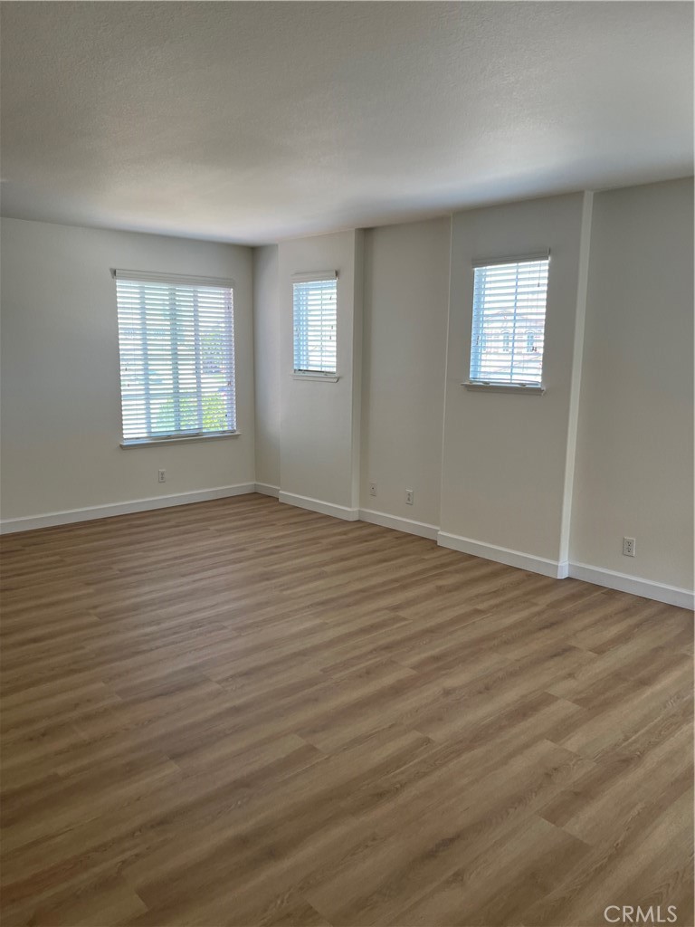 12772 Clemson Drive Eastvale, CA 92880 - Photo 25 of 28 a view of an empty room with wooden floor and a window