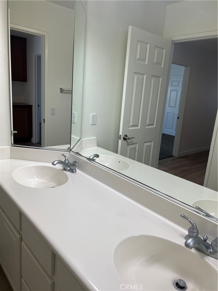 12772 Clemson Drive Eastvale, CA 92880 - Photo 28 of 28 a bathroom with a sink and a mirror