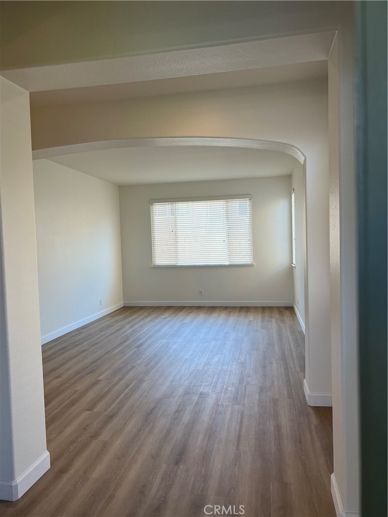 12772 Clemson Drive Eastvale, CA 92880 - Photo 4 of 28 a view of an empty room with wooden floor and a window