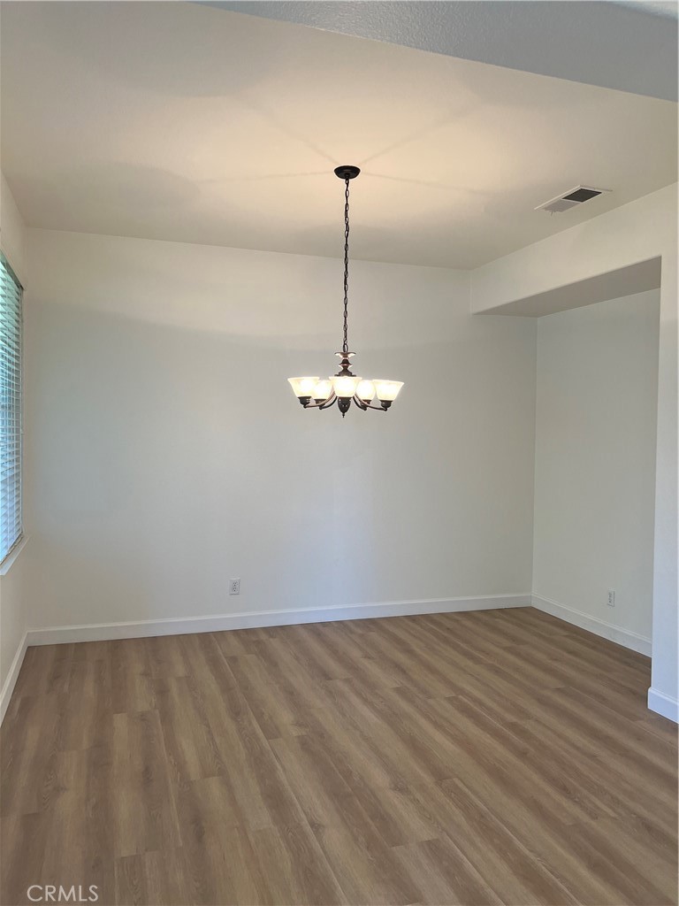 12772 Clemson Drive Eastvale, CA 92880 - Photo 5 of 28 a view of a room with wooden floor and ceiling fan