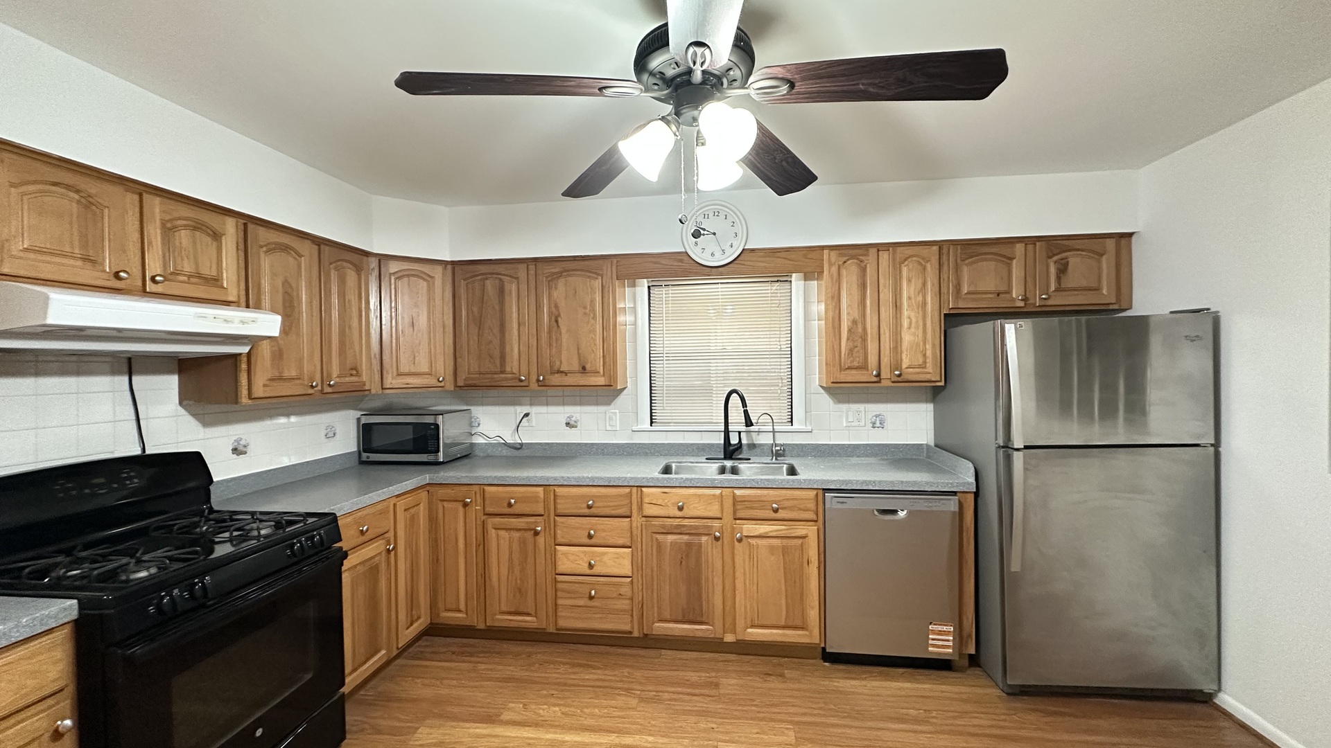 2745 West Berwyn Avenue, Unit 1 Chicago, IL 60625 - Photo 13 of 14 a kitchen with a sink a refrigerator a stove and cabinets