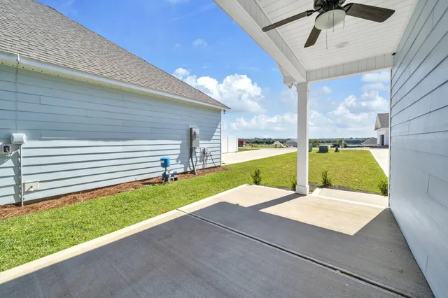 a front view of a house with a yard outdoor seating and garage