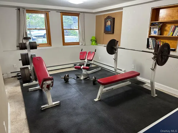 a room with gym equipment and windows