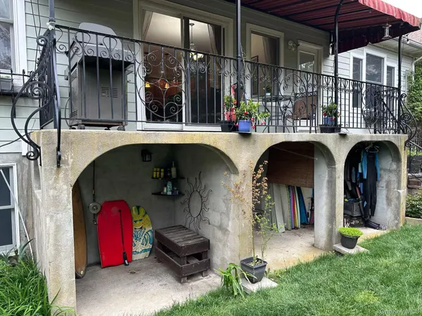a view of water fountain and a porch with furniture
