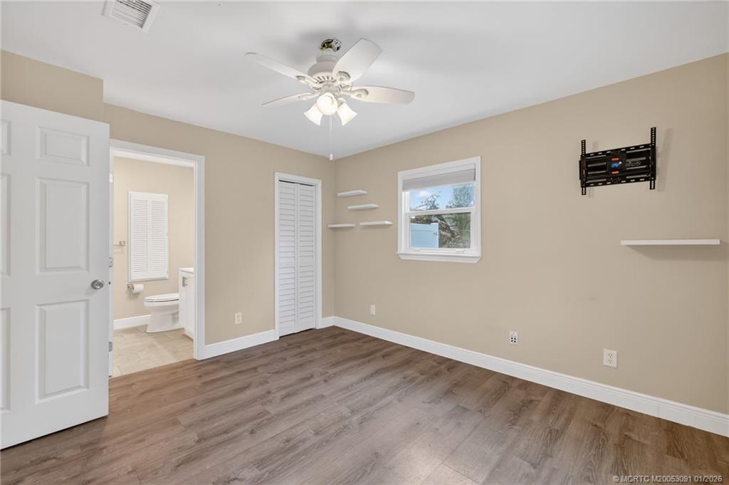 607 Southeast Cortez Avenue Stuart, FL 34994 - Photo 12 of 29 a view of an empty room with wooden floor