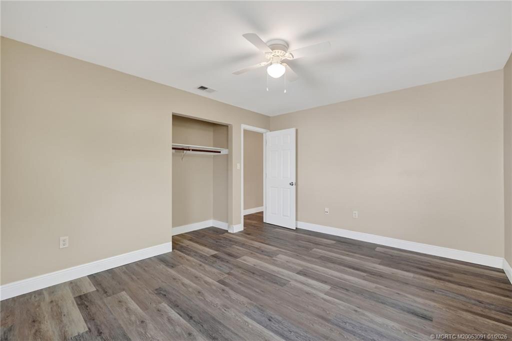 607 Southeast Cortez Avenue Stuart, FL 34994 - Photo 13 of 29 a view of an empty room with wooden floor