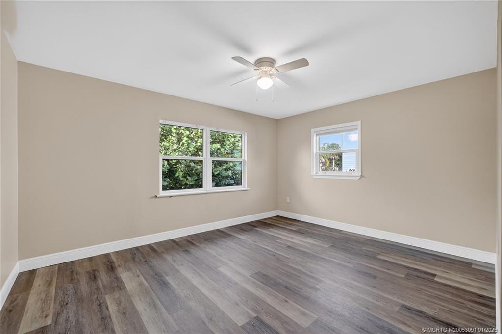 607 Southeast Cortez Avenue Stuart, FL 34994 - Photo 14 of 29 a view of an empty room with wooden floor and a window