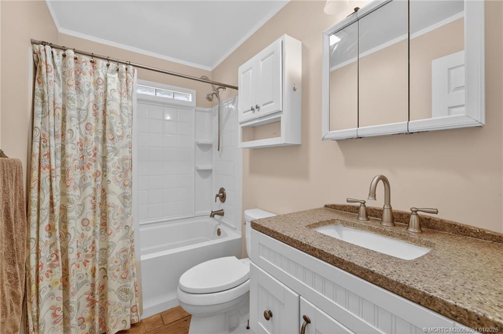 607 Southeast Cortez Avenue Stuart, FL 34994 - Photo 17 of 29 a bathroom with a granite countertop sink toilet and shower